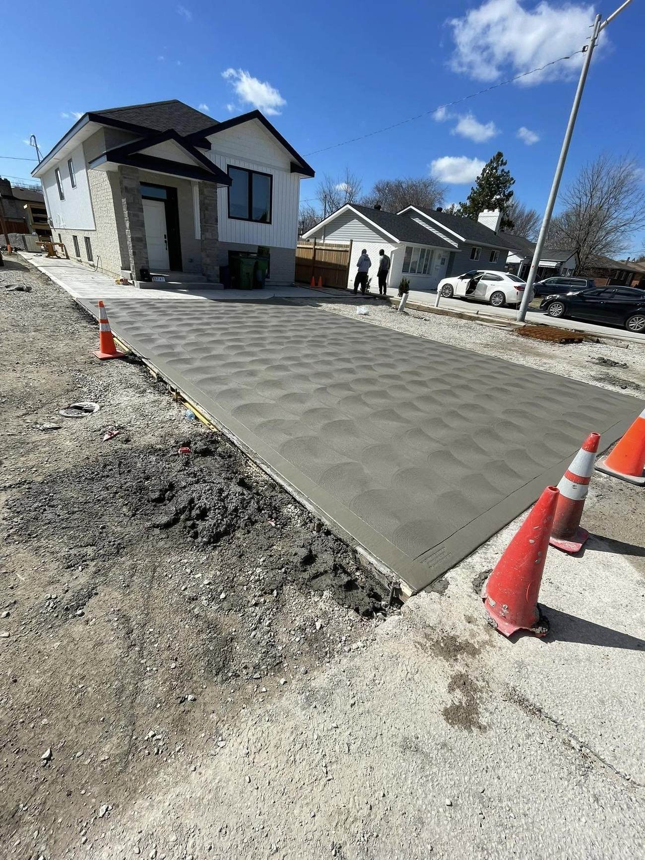 Freshly finished concrete driveway with curing protection