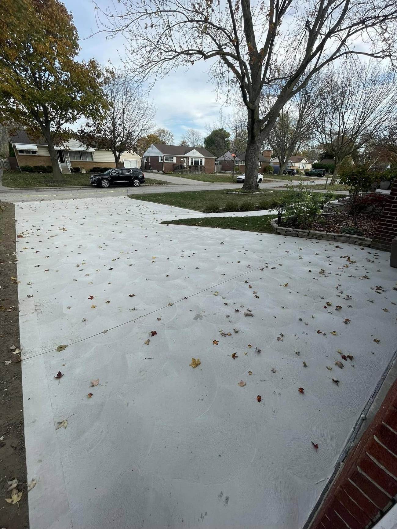 Wide broom-finished driveway in fall