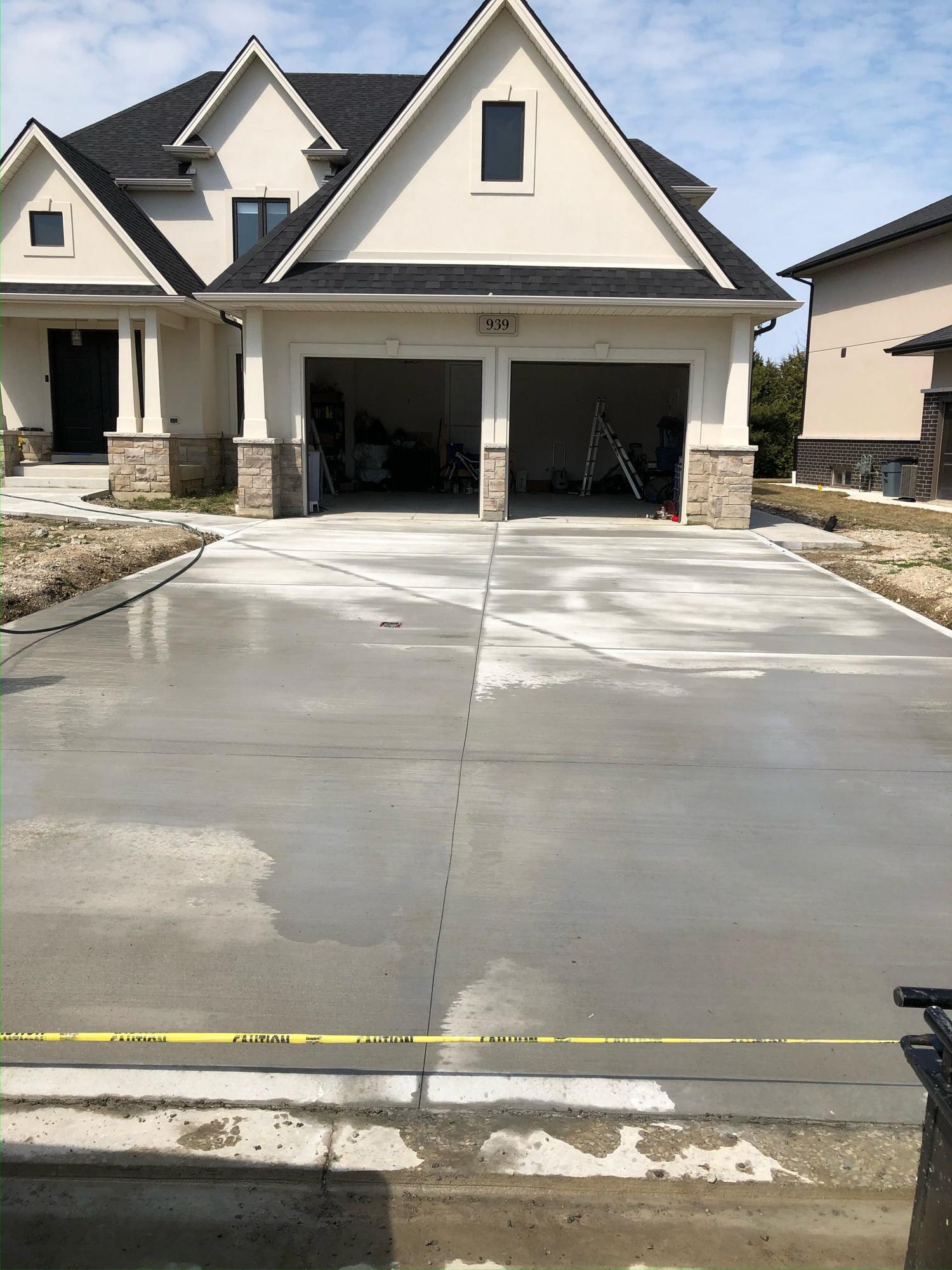 New concrete driveway and approach at a new build
