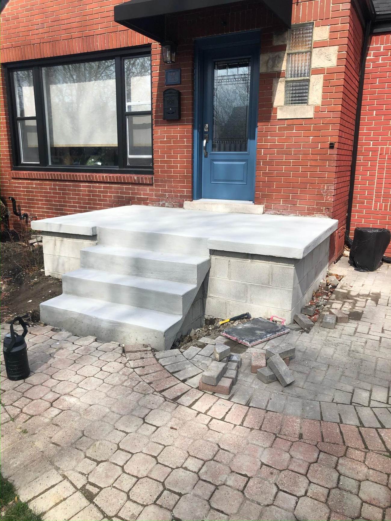 New concrete steps and porch entrance on a brick home