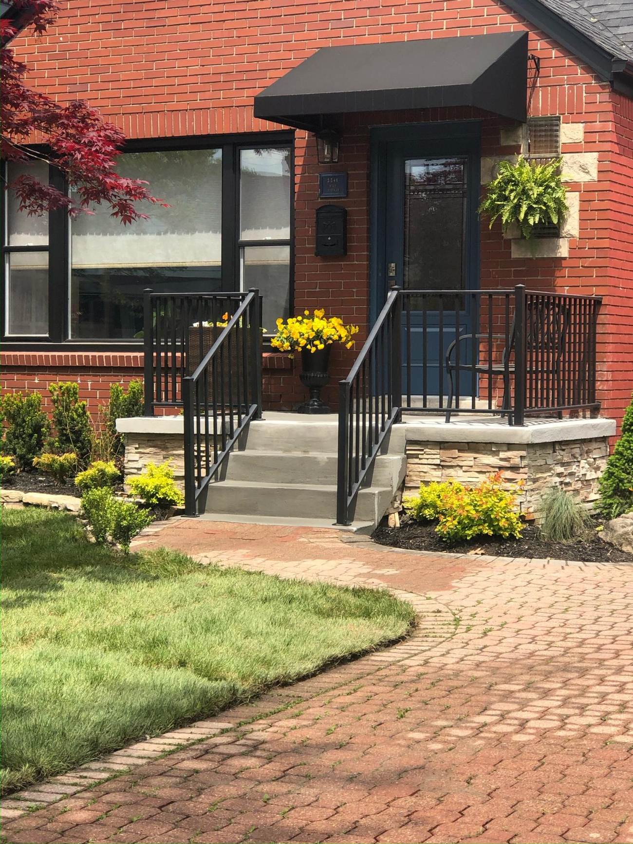 Rebuilt front concrete steps with railing