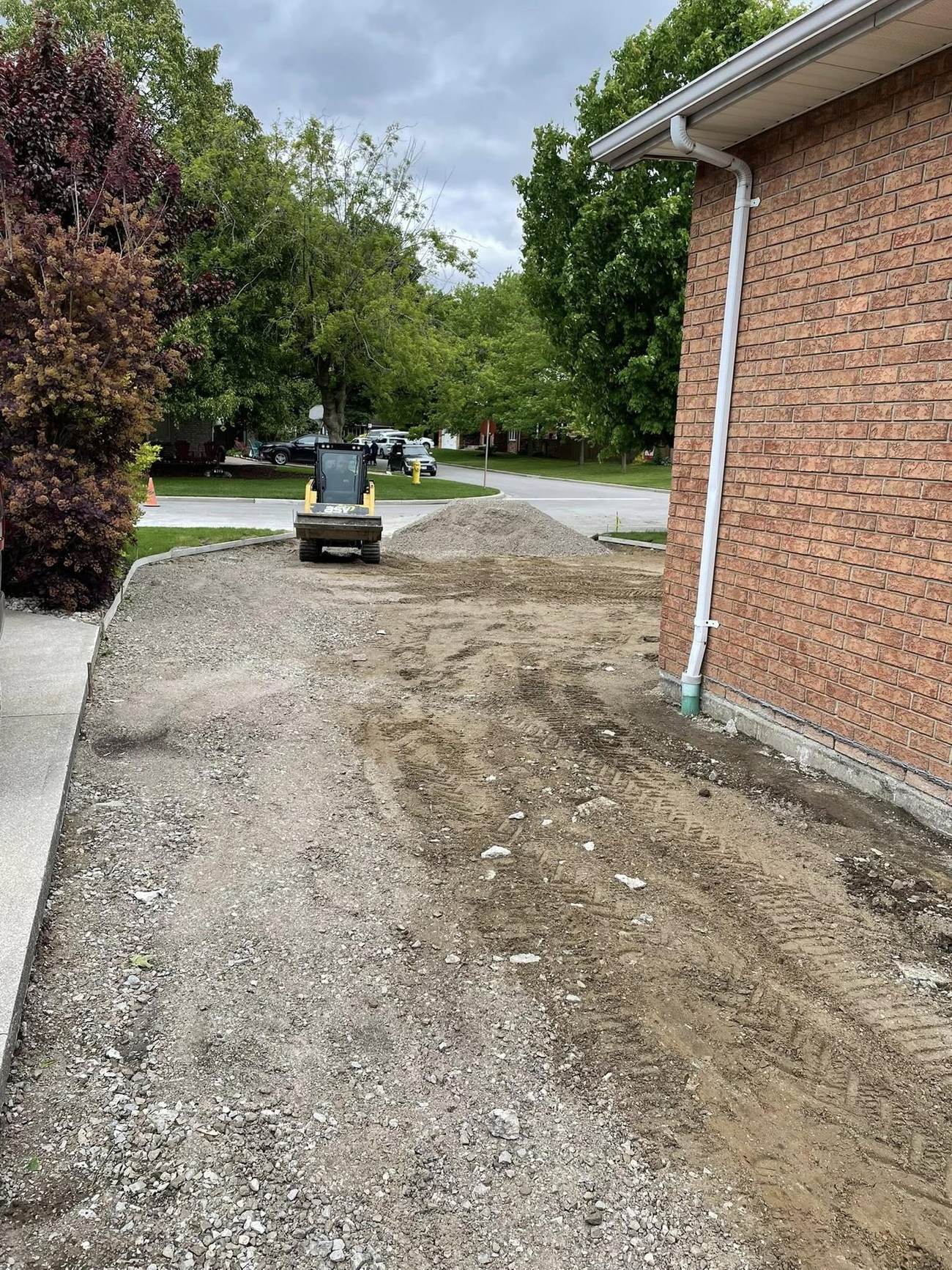 Graded and compacted stone base for a driveway