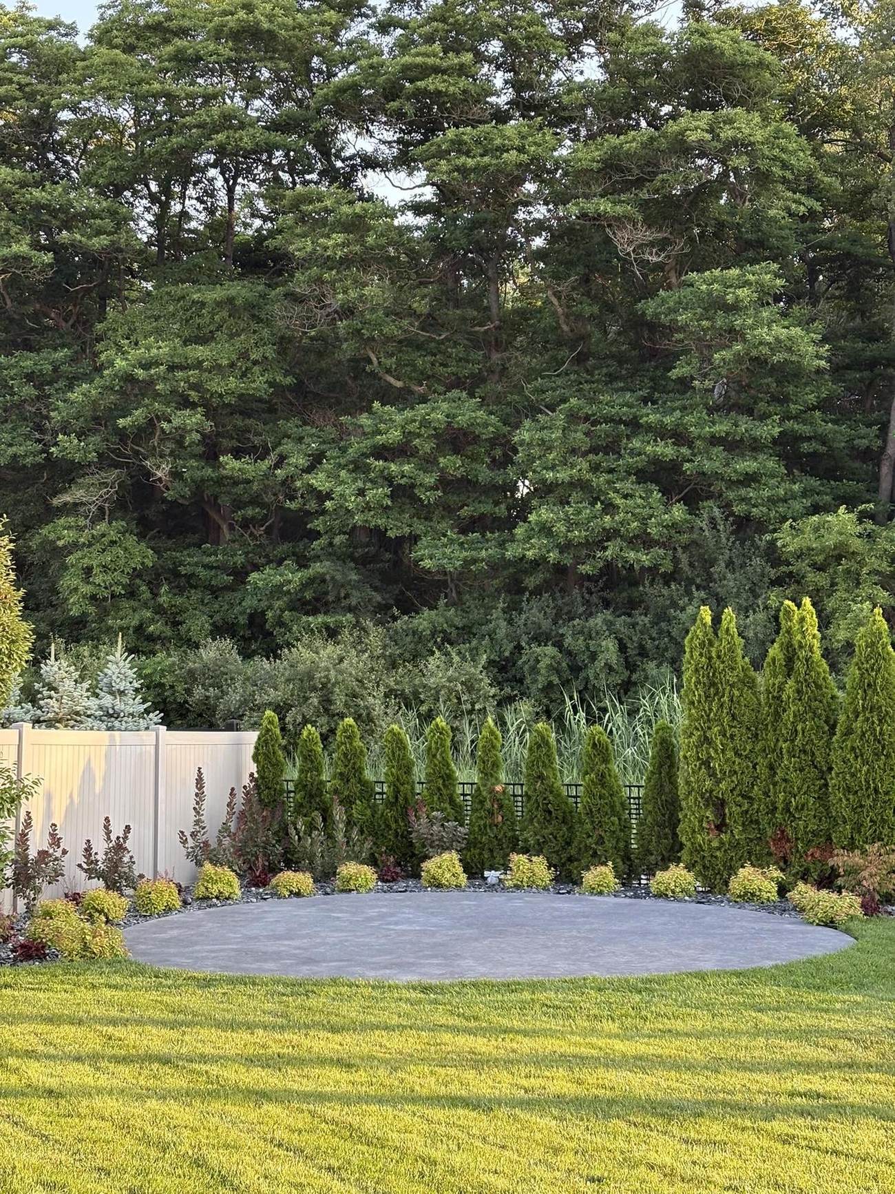 Circular concrete pad set into a landscaped yard