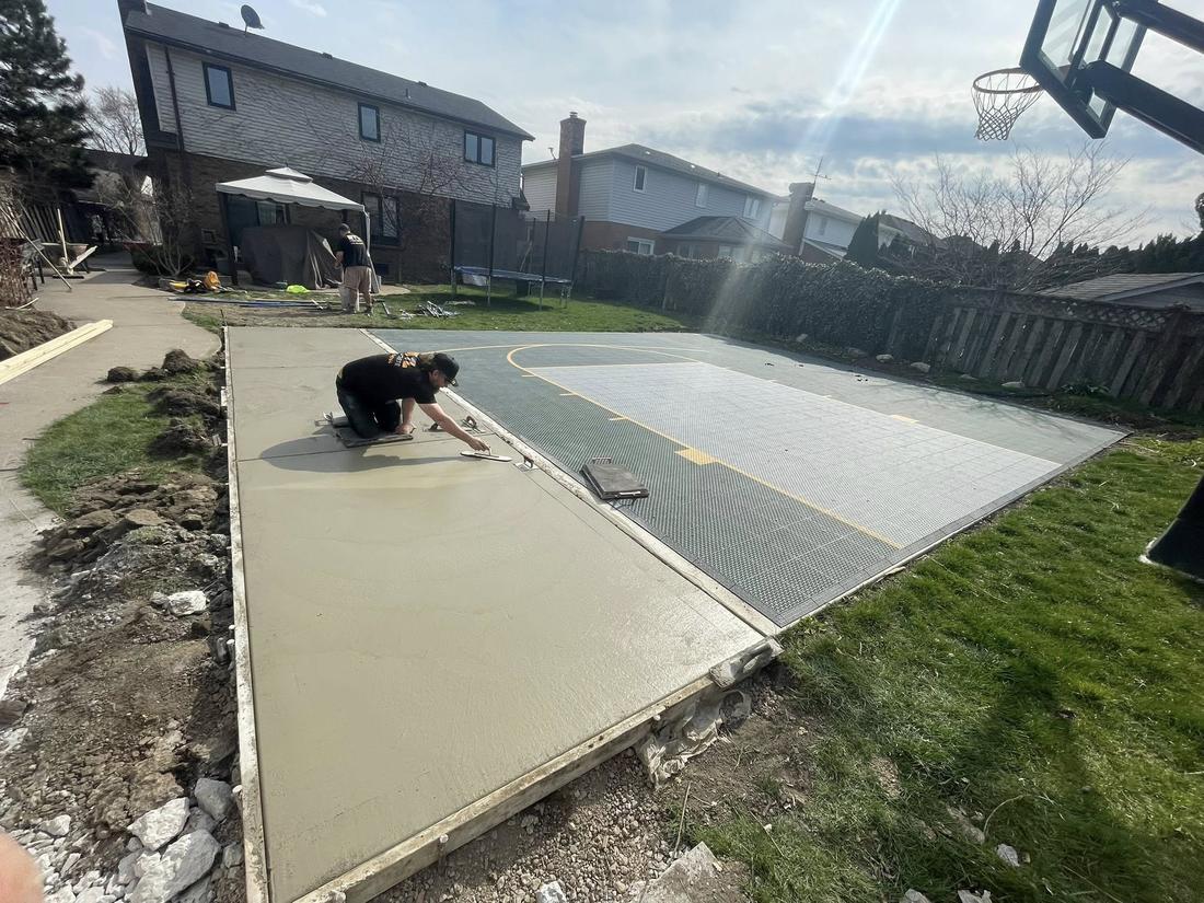 Crew hand-finishing a fresh concrete surface