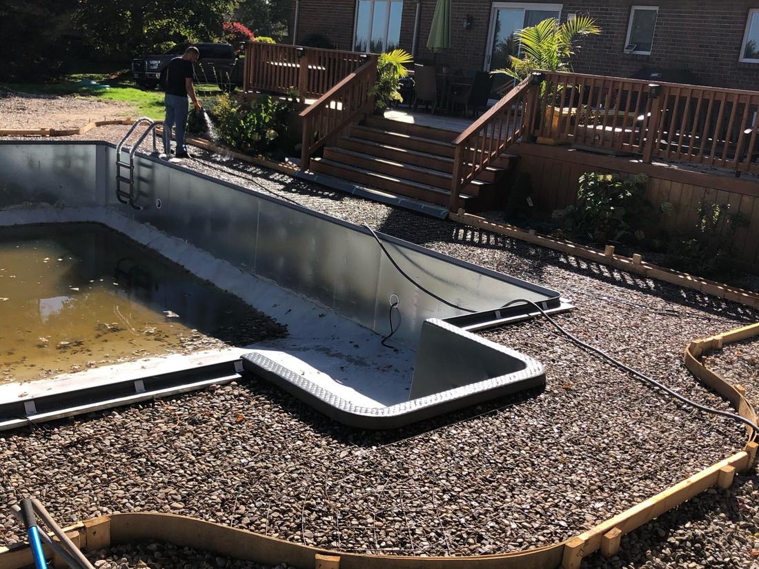 Curved forms and compacted gravel base prepared for a pool deck pour